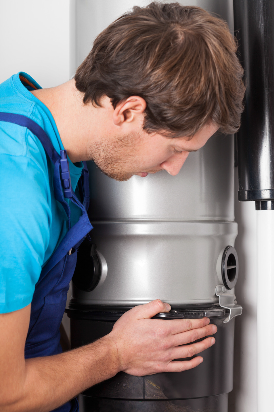 Technician fixing a central vacuum cleaner